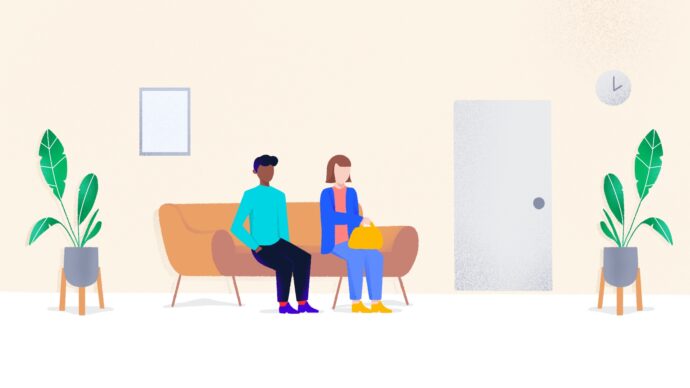 Two people sit on a sofa in a waiting room adorned with plants, a wall clock, and a closed door. The quiet room suggests more patients might soon fill the space.