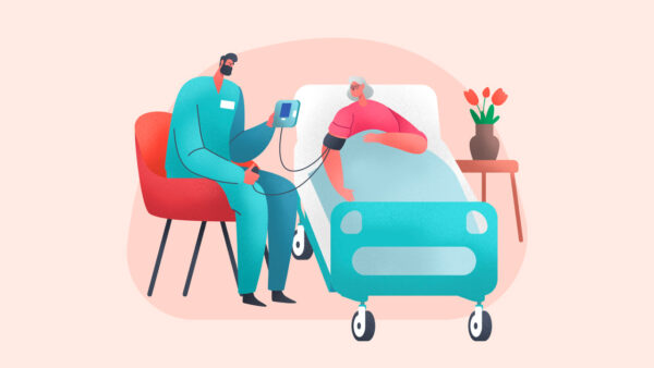 A healthcare worker with excellent bedside manner checks a patient's blood pressure beside a hospital bed, the care reflecting the compassionate standards vital in oncology. A vase of flowers brightens the nightstand.