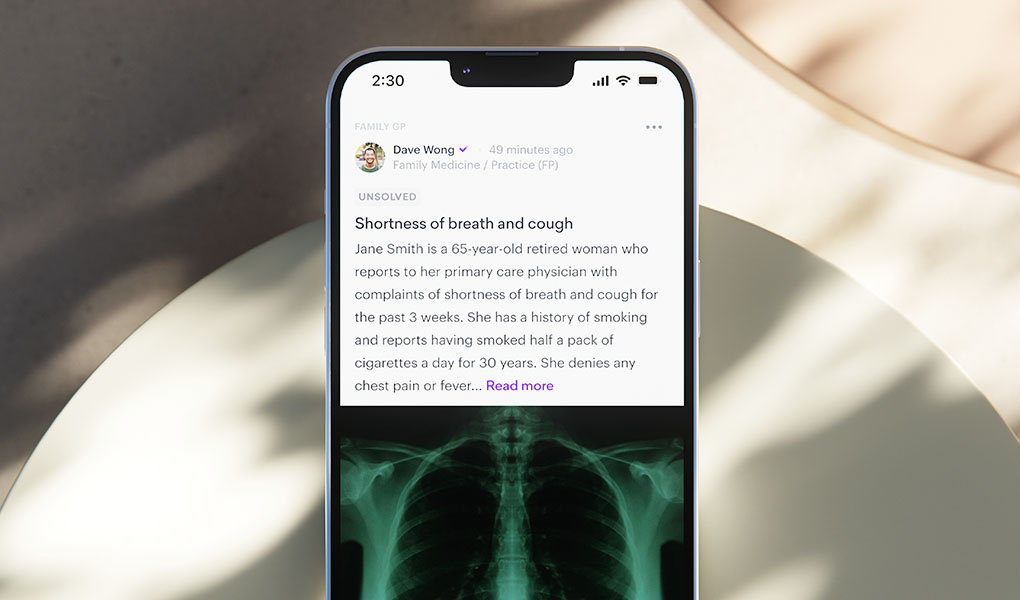 A smartphone showcasing a medical app, developed in partnership with healthcare professionals, displays patient information on shortness of breath and cough, complemented by an X-ray image.
