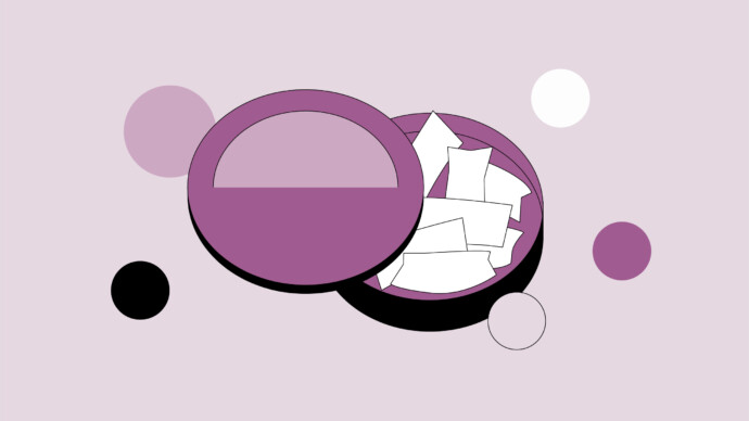 A purple container with a lid holds several white rectangular slips of paper, resembling nicotine pouches—a reminder to consider nicotine pouch health risks; various colored circles are in the background.