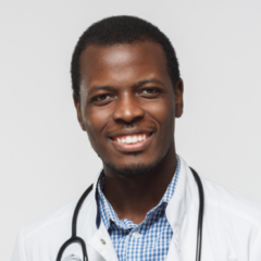 A smiling person in a white coat with a stethoscope around their neck stands ready to offer expert advice on the best websites for doctors.