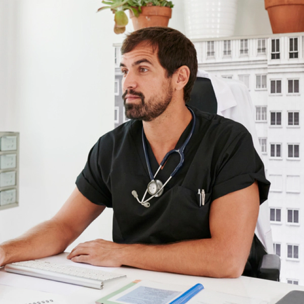 A physician sits at a desk